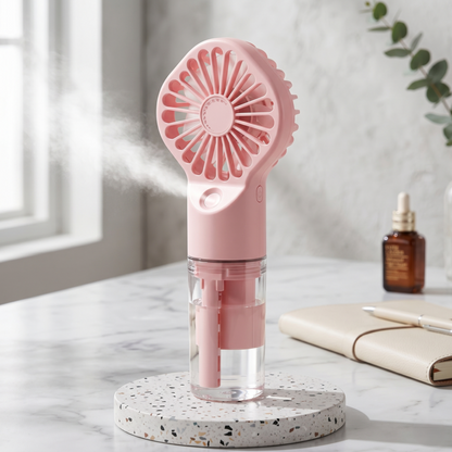 Aesthetic pink Retailark rechargeable mist fan on a marble surface showing misting functionality.